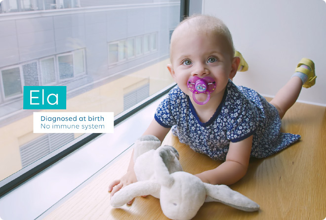 Young patient at Great Ormond Street Hospital clutches a teddy bear for comfort while posing by a window